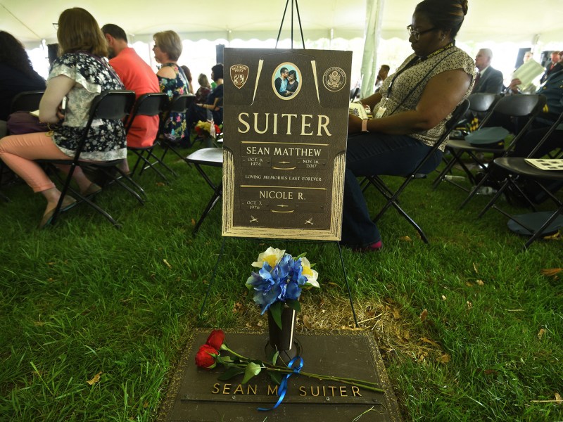A memorial for Baltimore homicide detective Sean Suiter, with flowers placed in front of it