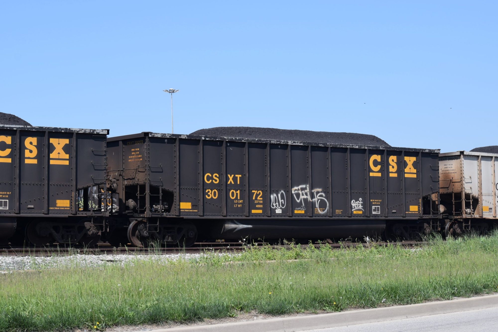 CSX train car in front of a pile of coal