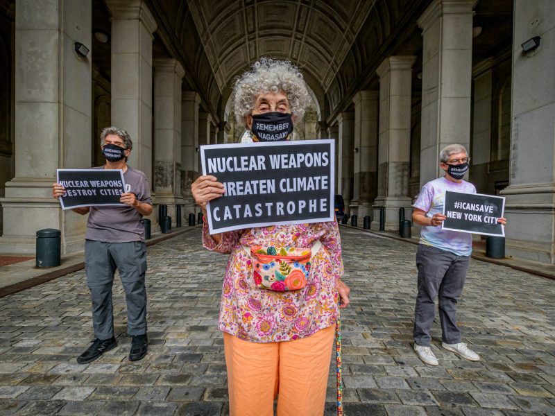 Nuclear disarmament protesters holding signs