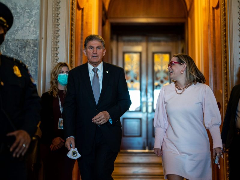 Sen. Joe Manchin (D-WV) leaves the Senate Chamber with Sen. Kyrsten Sinema (D-AZ)