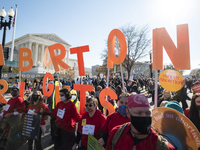Reproductive rights activists hold abortion rights cut out letters in front of the US Supreme Court building