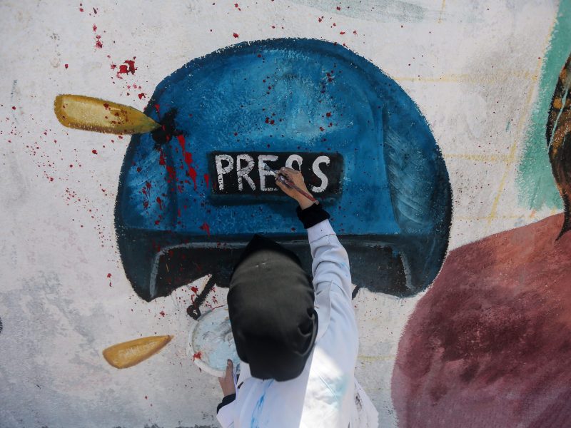 A Palestinian artist makes final touches on a mural of Al-Jazeera journalist Shireen Abu Akleh in Gaza City. Shireen Abu Aqleh, an Al-Jazeera correspondent, was killed by Israeli military forces while covering an invasion in Jenin refugee camp in the West Bank.