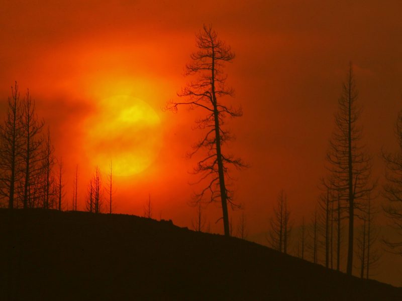 Smoke obscures the.sun as it sets on the burn zone of the McKinley fire.
