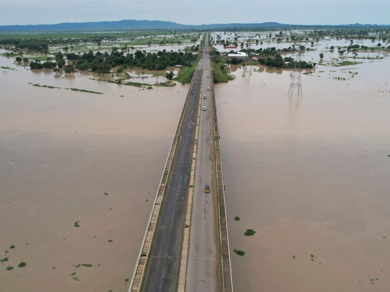 This aerial view shows local residents crossing the Numan bridge while driving to a safer grounds on September 25, 2022, away from the rising waters in Numan Community of Adamawa State, North East Nigeria.