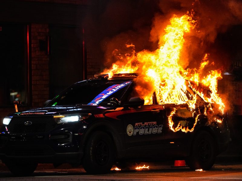 An Atlanta police vehicle is set on fire during a "Stop cop city" protest in Atlanta, Georgia, United States on January 21, 2023. Photo by Benjamin Hendren/Anadolu Agency via Getty Images