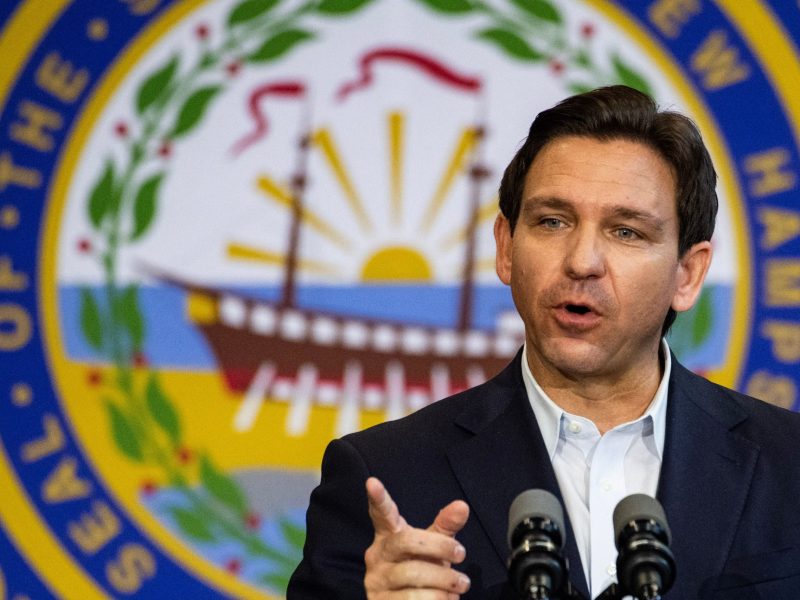 Gov. Ron DeSantis delivers a statement in front of a large Florida State Seal.