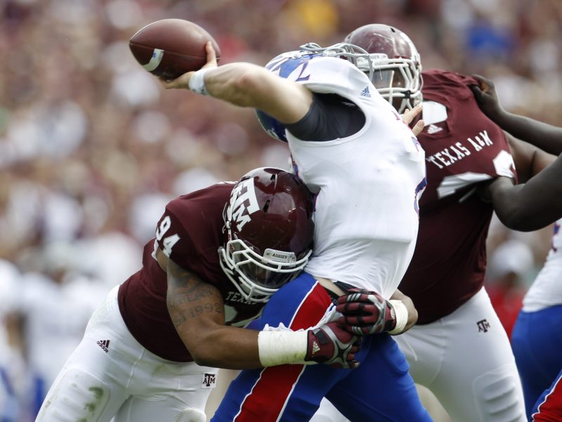 Kansas QB Jordan Webb (2) is sacked by Texas A&M Aggies linebacker Damontre Moore (94) and was off the field with an injury after getting sacked during the first half of the college football game at Texas A&M, Nov. 19, 2011. Photo by Karen Warren/Houston Chronicle via Getty Images