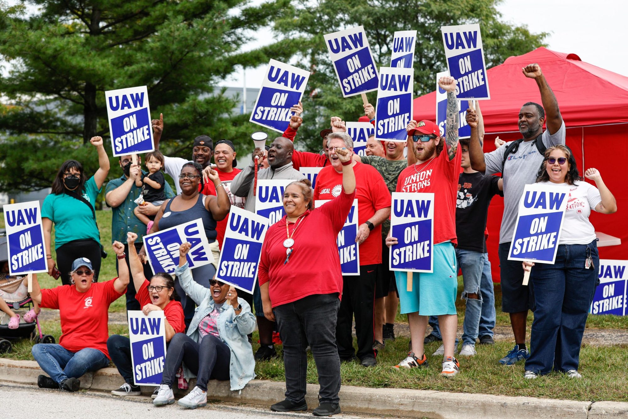 UAW members and workers at the Mopar Parts Center Line, a Stellantis Parts Distribution Center in Center Line, Michigan, hold signs outside the facility after walking off their jobs at noon on September 22, 2023. Photo by KAMIL KRZACZYNSKI/AFP via Getty Images
