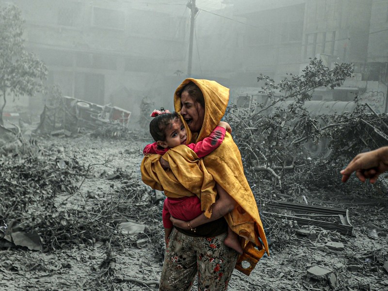 A woman holding a girl reacts after Israeli airstrikes hit Ridwan neighborhood of Gaza City, Gaza on October 23, 2023. Photo by Ali Jadallah/Anadolu via Getty Images