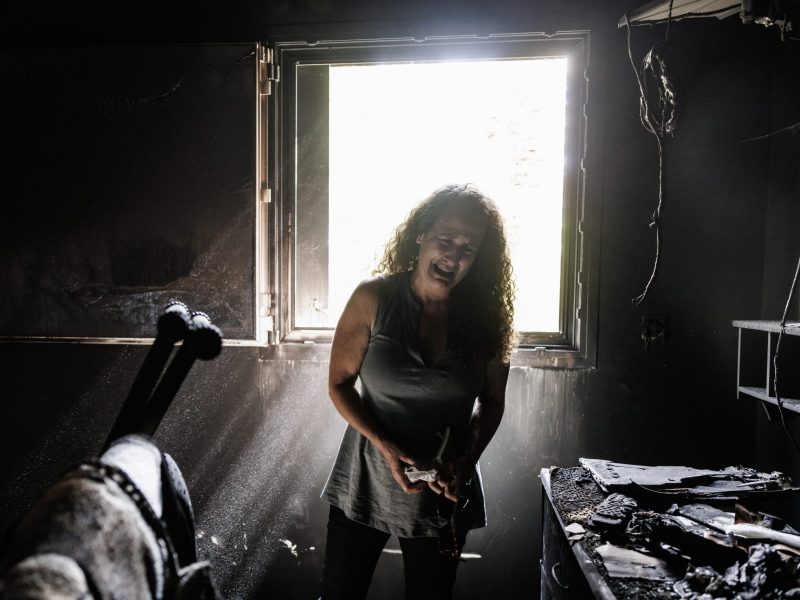 Kibbutz Nir Oz resident Hadas Kalderon, whose children have been taken hostage, and her mother and niece killed, breaks down in tears while looking through the burnt out home of her late mother Rina Sutzkever on October 30, 2023 in Kibbutz Nir Oz, Israel. Photo by Dan Kitwood/Getty Images