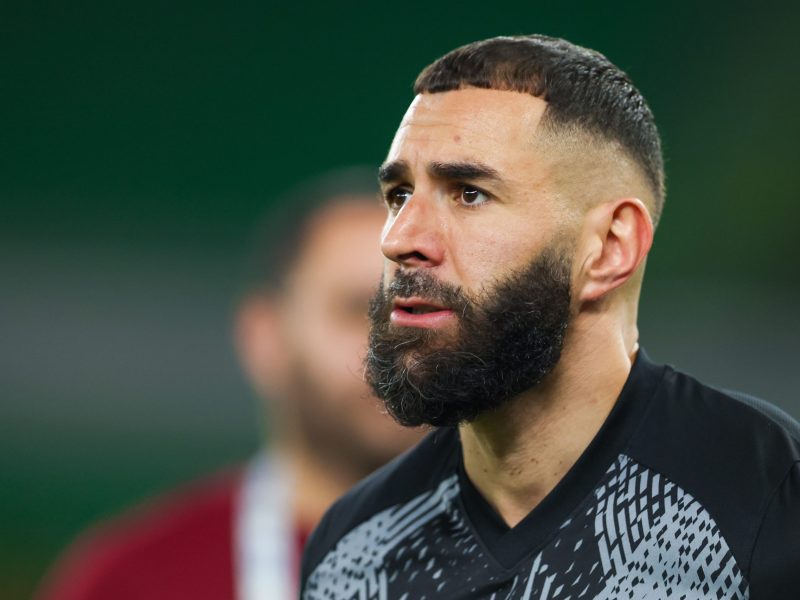 Close up of Karim Benzema, he has a beard and short hair with a fade cut.