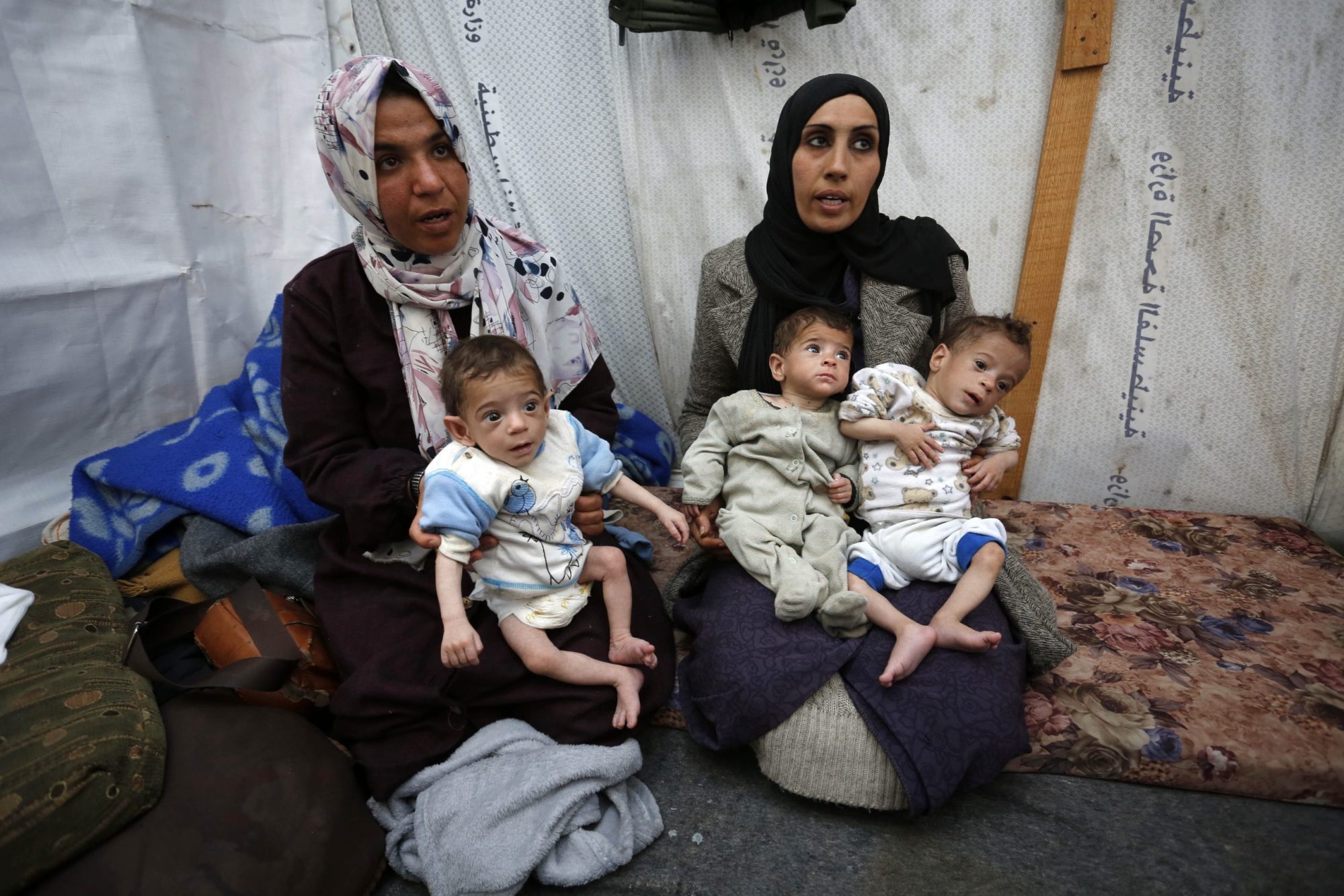 Baby triplets of Palestinian mother Nuzha Awad face the threat of dying from malnutrition and lack of medical care due to constant Israeli attacks and blockades as they take shelter in Nuseirat camp in Deir al Balah, Gaza, on March 25, 2024.