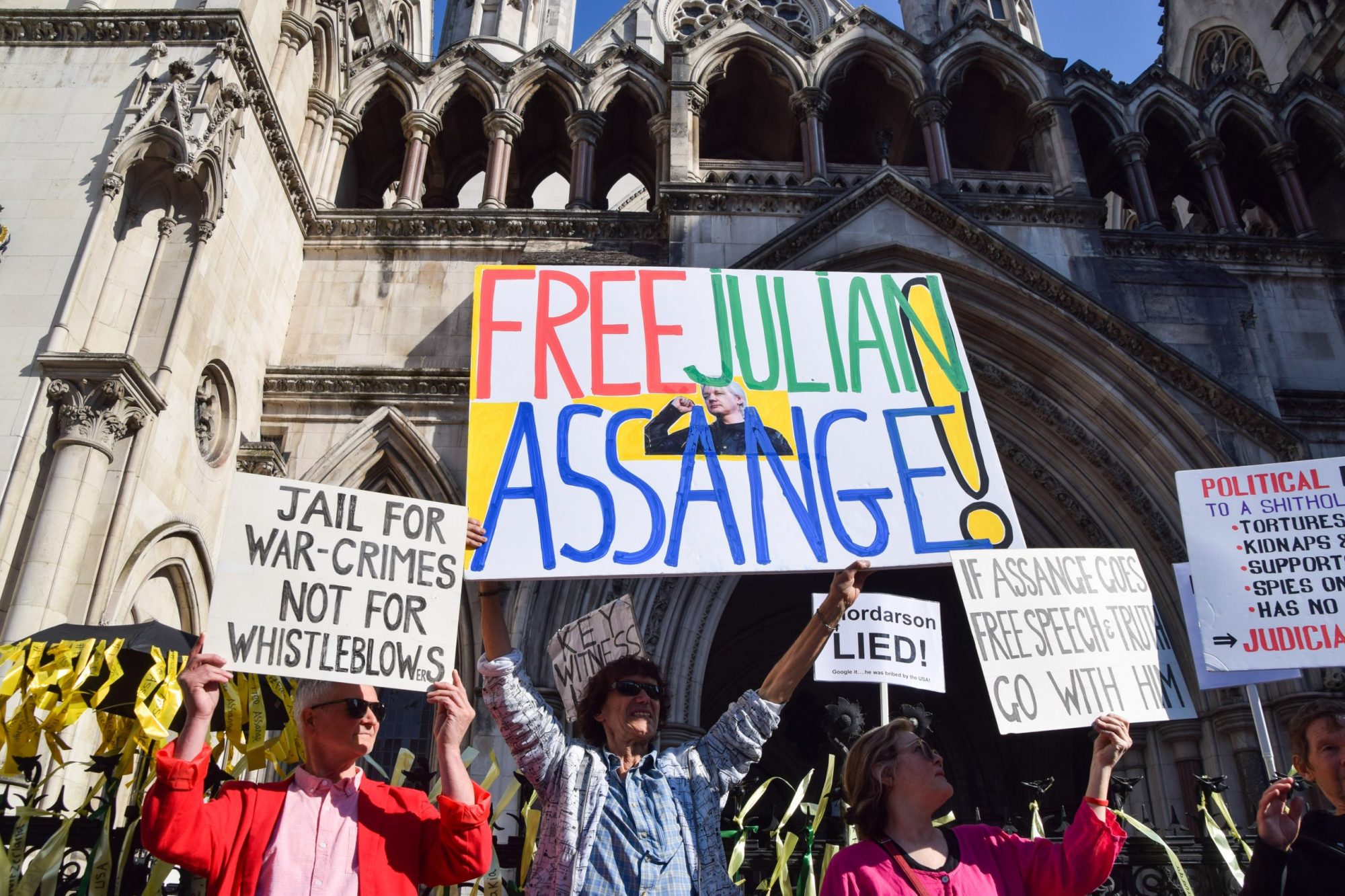 Protesters hold placards in support of Julian Assange during a demonstration outside the High Court ahead of Assange's extradition decision. Photo by Vuk Valcic/SOPA Images/LightRocket via Getty Images
