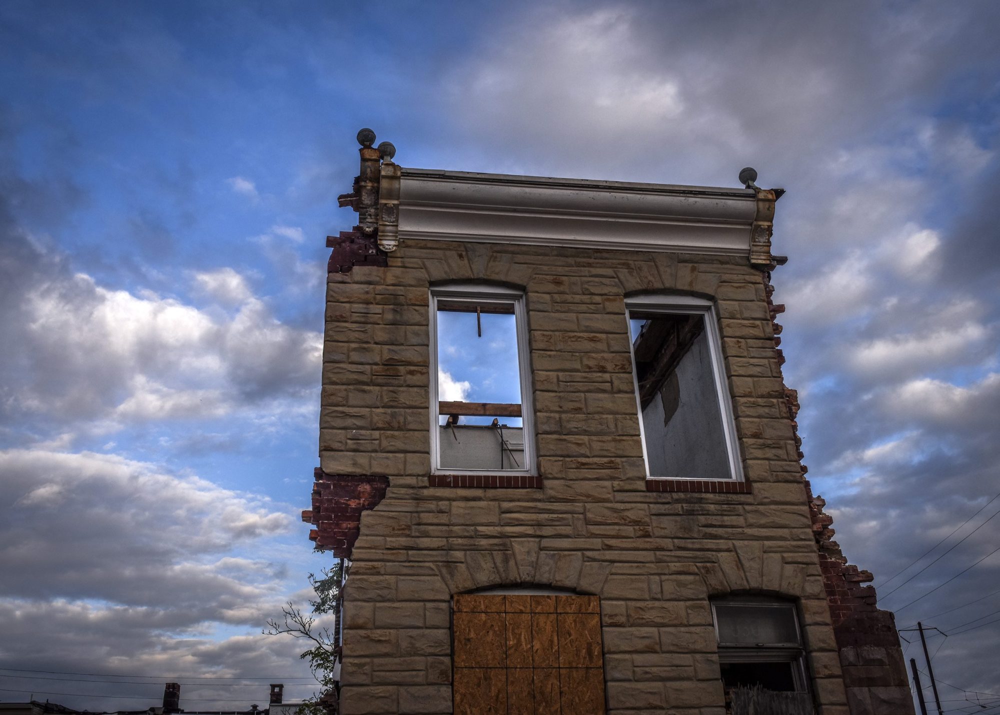 front of a heavily damaged brick building
