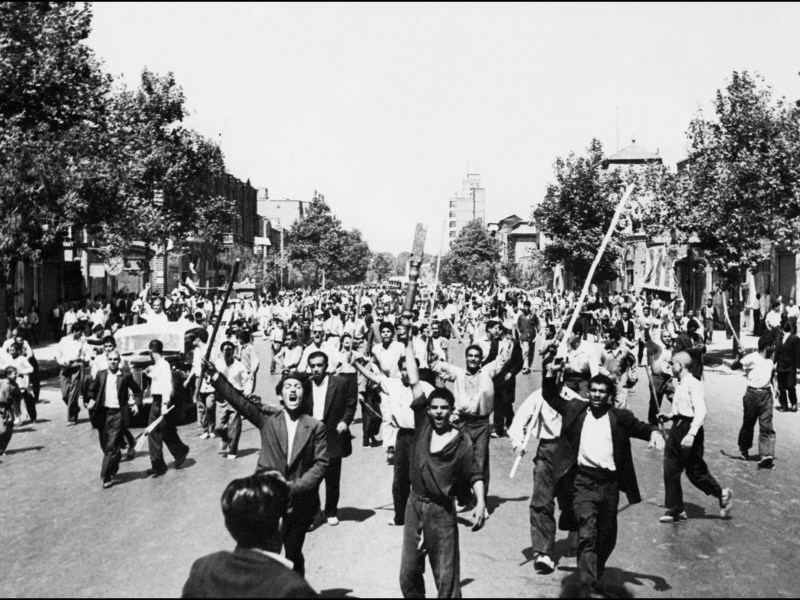 Rioters armed with staves shout slogans, during riots in Tehran, August 1953. Photo by -/INTERCONTINENTALE/AFP via Getty Images