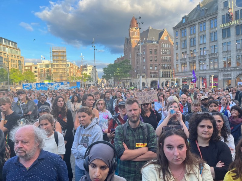 A large crowd of people at the Amsterdam rally to protest the Netherlands' treatment of asylum seekers.