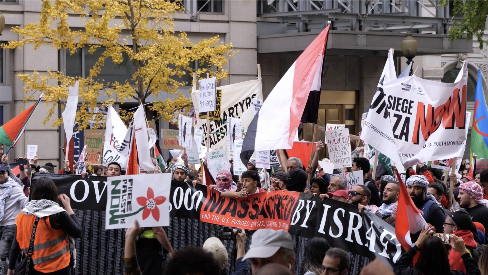 After hours of speeches and chants in Freedom Plaza for the Free Palestine! National March on Washington, which over 100,000 people attended on Sat., Nov 4, demonstrators begin to march toward the White House holding signs calling for an immediate ceasefire, an end to US aid to Israel, and an end to Israel's bombing of Gaza and violent Occupation of Palestine. Photo taken by Jaisal Noor on Sat., Nov 4.