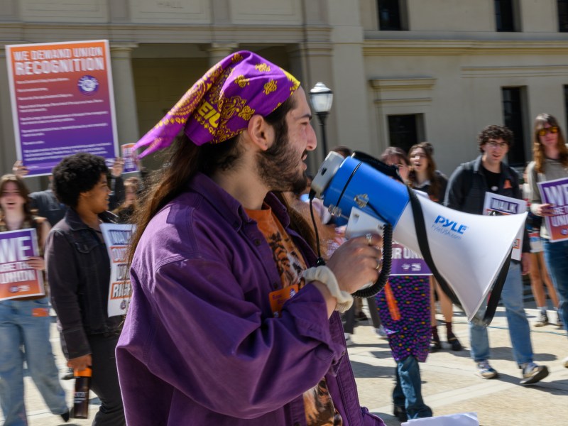 Student worker-organizer Noah Weitzner leads a chant with rallying student workers on Occidental College campus, 28 March 2024.