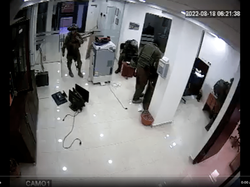 Screenshot of video from the Union of Agricultural Work Committees office showing officers removing office equipment.