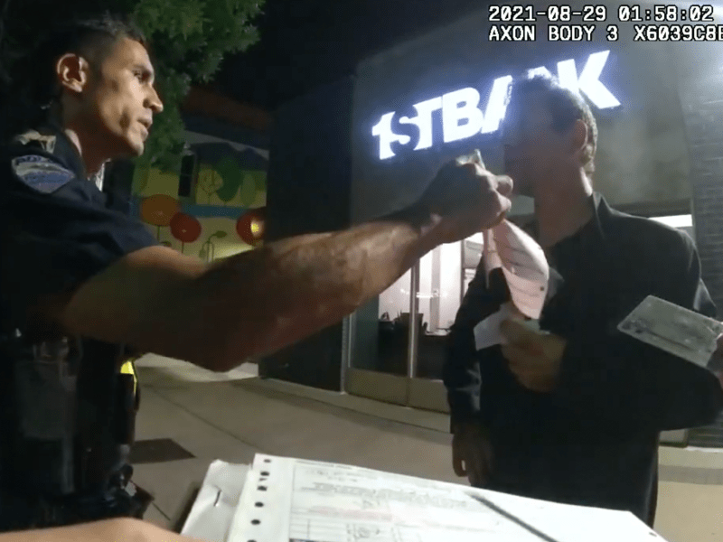 Ft Collins Police officer Parks attempts to serve Colorado resident Andru Kulas with a petty tresspass citation. Photo courtesy of the Fort Collins Police department Body Camera Unit.