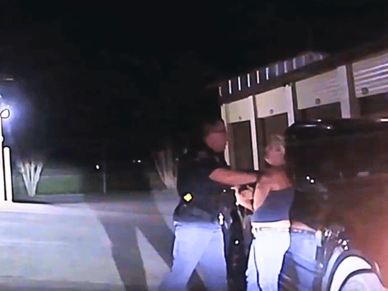 Dash Camera still photo courtesy of the New Braunfels Police Department Description- The dash camera of New Braunfels, TX Police Department Patrick S Ackers captures an incident in 2021 where he arrests a woman while using her family's storage unit.